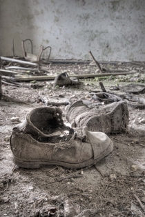 Shoes disintegrate in an abandoned home in Ireland by Peter Irvine 