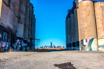 Shot of the Chicago skyline thru the abandoned Damen Silos in the foreground 