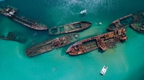 Small speed boats explore the turquoise waters that house a ship graveyard full of yesteryears vessels TANGALOOMA AUSTRALIA