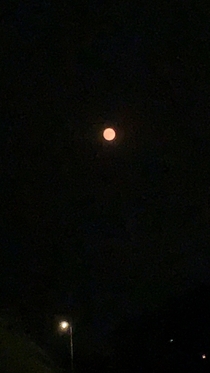Smoke from the fires in California are passing over Arizona and caused the moon to turn red-orange color Sorry for poor camera quality My phone doesnt take good pictures of the moon