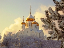 Snow caps the golden domes of the Church of the Transfiguration in the Republic of Karelia Russia 
