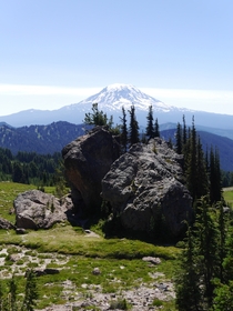 Some random massive boulders in the middle of this mountain meadow And Mt Adams Washington in the background 