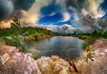 Storm clouds over the flooded quarry in Ukraine