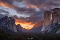 Sun setting the clouds and Horsetail Fall ablaze in Yosemite Valley on  February  