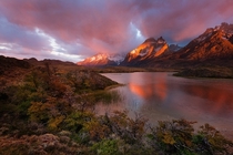 Sunrise light paints the Cuernos del Paine massif in amazing red light Patagonia Chile  Photo by Hougaard Malan
