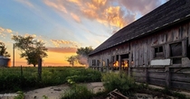 Sunset by an abandoned barn