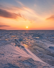 Sunset over frozen Lake Erie Headlands Beach State Park OH 