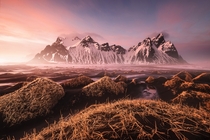 Sunset splashes a rosy tint over the landscape The mountain is the -foot -meter Vestrahorn a main landmark of southeastern Iceland  by Fabrizio Fortuna 