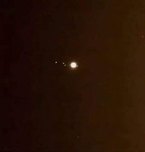 Telescope view of Jupiter and its Galilean moons