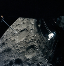 The Apollo  crew photographed the Moon out of the Lunar Module overhead rendezvous window as they passed by the deactivated Command Module is visible 