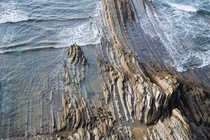 The beaches around North Bilbao Spain have beautiful sedimentary rocks that emerge from the sea 