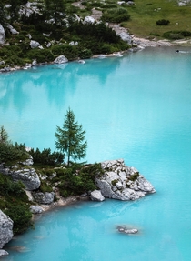The bright blue water of Lago di Sorapiss in the Dolomites 