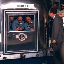 The crew of Apollo  being addressed by President Nixon as they wait in quarantine after returning from their historic mission to the Moon  July  