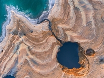 The Dead Sea is shrinking and as its waters vanish at a rate of more than one meter a year hundreds of sinkholes some the size of a basketball court some several storeys deep are devouring land where the shoreline once stood  Photo by Cristian Kirshbom