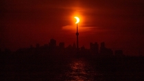 The  eclipse rising behind the CN Tower