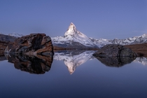 The Matterhorn is reflected in the Stellisee about one hour before sunrise 