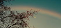 The moon and a fading rainbow