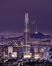 The moon between two towers in Seoul Korea 