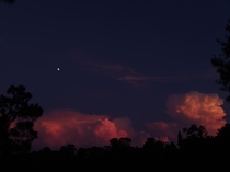 The Moon sitting above a Florida thunderstorm