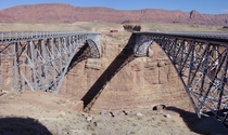 The  Navajo Bridge at left and the  Navajo Bridge at right across the Colorado River at Marble Canyon The Echo Cliffs are in the background to the east 