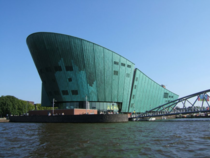 The oxidized copper-clad iconic house of NEMO was designed by Italian architect Renzo Piano to resemble a ship at anchor in the middle of the old port in Amsterdam