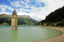 The partly submerged church bell tower of Lake Reschen South Tyrol Italy 