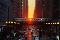 The setting sun is visible down the streets of Chicago during the spring equinox 
