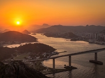 The setting sun sinks behind the low mountains framing Vila Velha a coastal city in the Brazilian state of Esprito Santo Victor Lima 