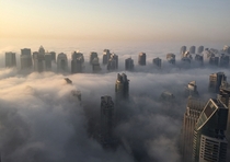 The skyline of Dubai covered in an early-morning fog Rene Slama 