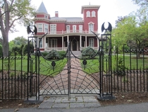 The Stephen King Home - Bangor Maine - Eye-catching red Victorian-style mansion featuring bats spiders and a web on its front gates - Soon to be a writers retreat and an archive of the famous horror authors work