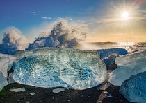 The sun together with the waves smashing against ice blocks at diamond beach in Iceland  - more info in the comments