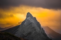 The sunset burning through the clouds behind Mt Wintour in Kananaskis Alberta Canada 