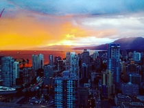 The sunset makes the ocean look like lava flowing over the city Vancouver BC