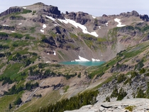 The turquoise coloured Goat Lake sits in a small steep basin in Goat Rocks Wilderness Washington 