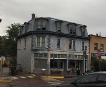 The upper levels of this building are abandoned while the first level remains an antique shop 