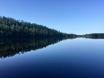 The water is so calm and reflective that honestly I could have posted this photo upside down and youd never know Lake Temagami ON Canada 