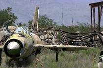 The wreckage of an abandoned Soviet Mig- Fishbed aircraft sits with rusted hardware in an open field near Bagram Air Base Afghanistan 