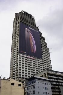 This abandon sky scrapper in Bangkok is now the home for one of the largest billboards Ive seen 
