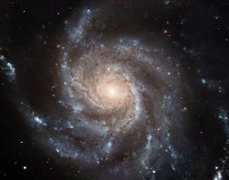 This giant spiral disk of stars dust and gas is  light-years across or nearly twice the diameter of our Milky Way galaxy M is estimated to contain at least one trillion stars 