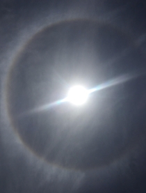 This is a picture I took of the sun today it had a rainbow ring around it Ive never seen anything like it