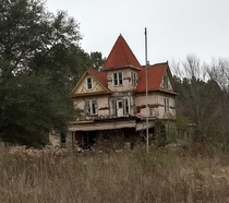 This three story house was built in  in Carthage Texas and was moved in about  to a property outside of Arp Texas It had been abandoned after the house started to leak The owner had been a hoarder and has since passed away