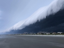 this tsunami-like cloud over the beach