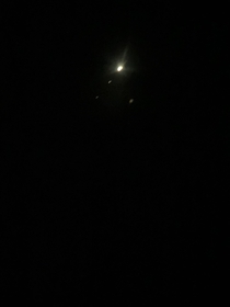 Took a picture with my phone looking through my telescope at Jupiter and its moons