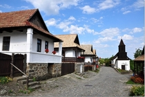 Traditional houses and chapel in Hollk Hungary 