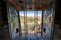 Train cars parked behind a nudist colony in the deserts of California 