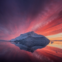 Tranquil waters colored by the reflection of blazing skies in Greenland by Daniel Kordan 