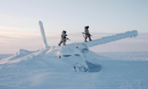 Two Canadian rangers conducting a survey mission on Cornwallis Island inspect a frozen wreckage of an aircraft that crash landed in that area many decades ago Nunavut Territory circa s