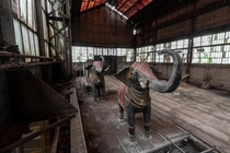Two gigantic elephants in the middle of an industrial ruin 