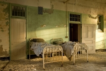 Two patient beds at sunset at the abandoned insane asylum in Buffalo NY 