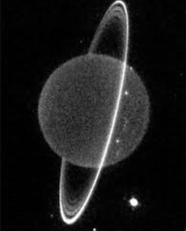 Uranus in infrared showing some of its moons and its ice rings Uranus was knocked on its side long ago and revolves with its North and South Poles alternately facing the Sun